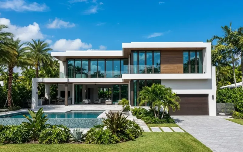 Modern two-story South Florida home with large glass windows overlooking a pool